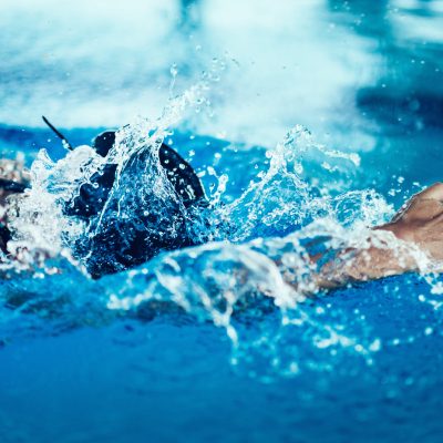 Professional swimmer in training, indoor swimming pool